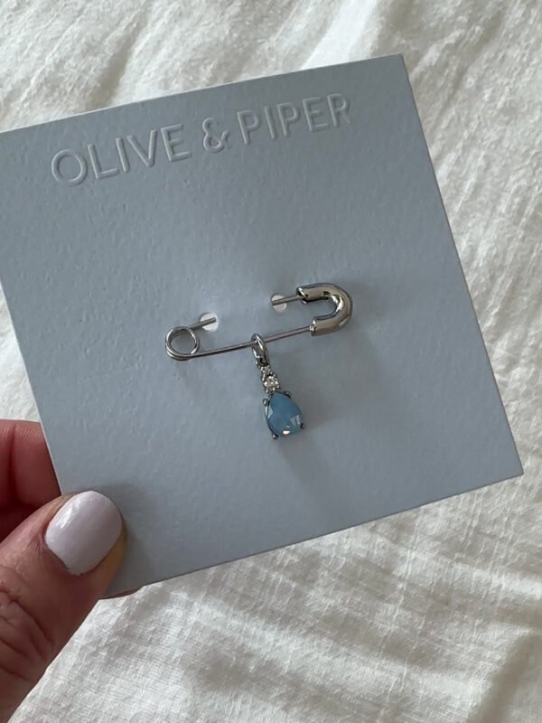 Person holding Olive & Piper's Something Blue Pin.
