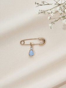 Olive & Piper's Something Blue Pin. A sky blue, pear cut gem charm for a modern twist on tradition.
