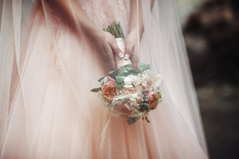 A bride holding a bouquet of flowers.