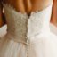 A close-up of a woman's back in a beautiful wedding dress.