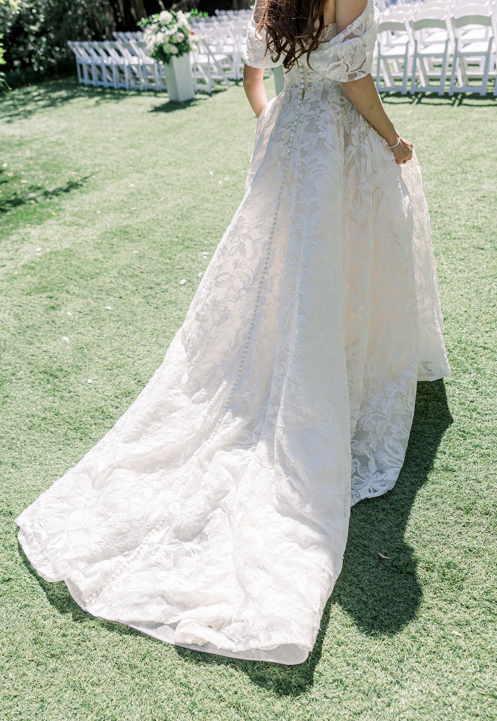 Lace wedding gown with a buttoned back and flowing train